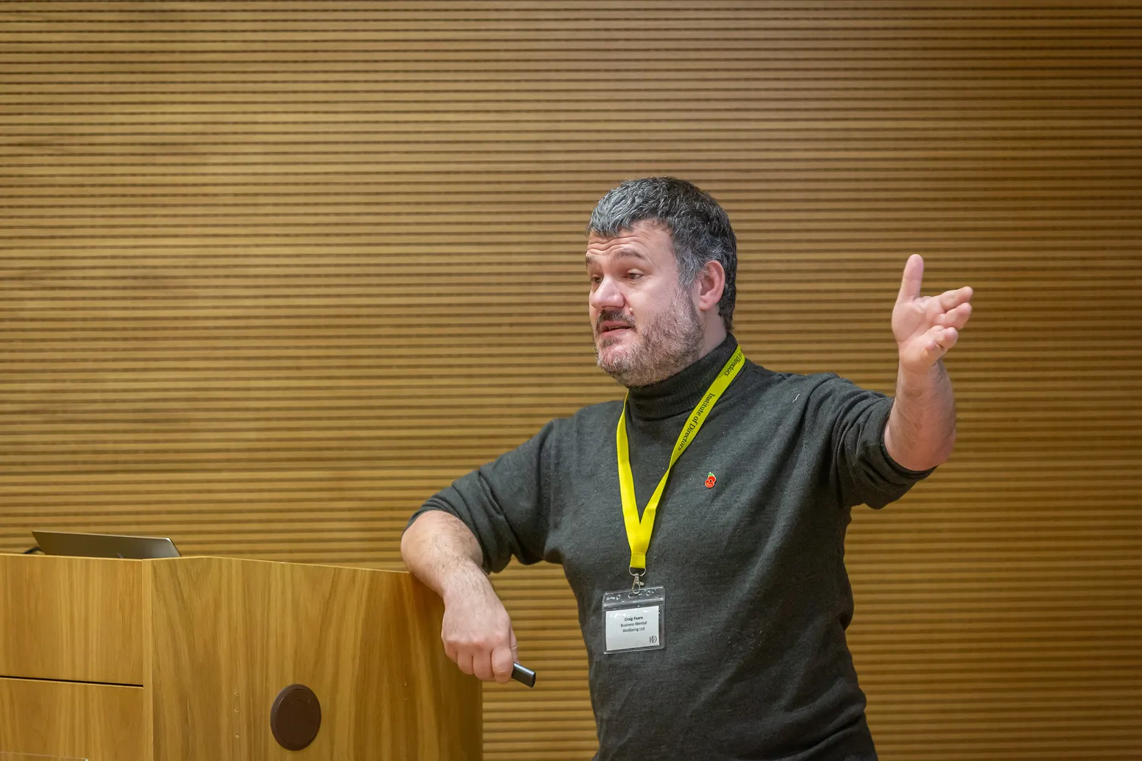 Craig Fearn speaking at a lectern at an Institute of Directors event